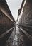 Street in Cuzco, rainy day, wet pavement, stone pathway, couple walking hand in hand in the rain