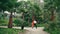 Street dancers dancing latino style in tropical park. Performers enjoy dance.