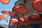 The street is decorated with many red color open umbrellas