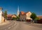 Street of Dej city, Cluj County, Transylvania, Romania. Gothic Reformed-Calvin Church on background