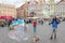 Street entertainer creates big bubbles by using soapy water and a rope in hand and people have fun with it