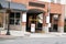 Street entrance to a parking garage in a building. There is a lot full sign blocking the entrance. There are several blank signs.