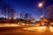 A street in the evening in winter with bus stops