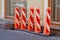 Street fences in the form of tall orange pillars of plastic