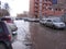 A street flooded with meltwater with stuck cars flooded the Parking lot in the spring