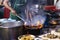 Street food in Bangkok Bangkok Thailand - Oct 24, 2020 :- Chef cooking with fire with frying pan on gas hob