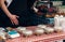 street food festival. salads in plastic boxes, man cooking fast