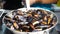 Street food mussels and shells. Cooking and mixing seafood in with spicy sauce large pan. Sale street food on local