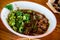 Street food noodles In a tile bowl on the Asian wood floor