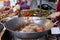 Street food in Thailand. deep-fried chicken using a large frying pan with boiling oil. Food from carts, travel and local