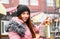 Street food. young woman holding Trdlo or Trdelnik, Traditional tasty baked Czech Republic and eating oudoor