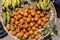 Street foods in Lagos Nigeria; banana and Agbalumo or African star apple in  a basket by the roadside.