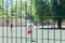 Street football, teenagers are playing. View behind the metal fence