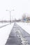 Street freshly cleaned by snowplow in a city full of snow