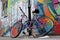 Street graffiti wall parked damaged wheel bycicle