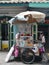 Street hawker in small alleyways Bangkok old district Talat Noi.