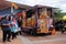 Street hawkers using food trucks to serve their business to the customer.