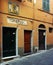 Street in the historic center: a glimpse of a frieze window and a votive image on a three-door building