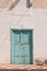 Street and a house with blue wooden door