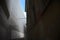 Street of a italian town with a facade covered by a white tarp for renovation