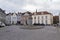 Street junction with a water fountain and old houses