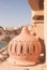 Street lamp on the balcony at sunny day with beach and umbrellas, sunbeds, sea as a background