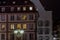 Street lamp and buildings with highlighted windows, night view of Strasbourg