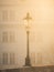 Street lamp on Charles Bridge in foggy morning, Prague, Czech Republic. Sepia image
