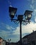 Street lamp, city and blue sky with clouds