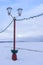 Street lamp on embankment of frozen lake