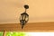 A street lamp hangs on the ceiling of the veranda.