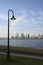 Street lamp lighting a footpath against Perth financial centre skyline