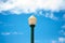 Street lamp lump lighter green on blue sky white clouds day