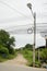 Street lamp and many wires messy with power line cables at beside road