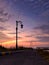 Street lamp silhouette near Setu patok dam when sunrise