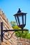 Street lamp on a textured brick wall autumn