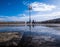 Street lamp which is displayed in a puddle against the background of blue sky and white clouds in the ancient part of