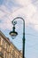 Street lamp, wires, street sign against blue sky