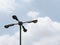 Street Lamppost with four arms on cloudy blue sky