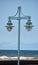 Street Lamps against Ocean Landscape