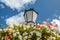 street lantern with flowers against blue sky