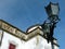 Street lantern made of black cast iron against a blue sky