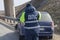 Street lighting. the blue car crashed into a metal fence. The inspector prepares the documents. Close-up