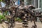 Street metal sculpture of a robot dog made of old cars parts and details, auto-waste.