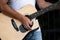 A street musician guitarist stands and grazes in a park on alley avenue in the city on the street near the fence shot close-up and