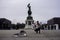 Street musician performing in front of Archduke Karl statue at Heldenplatz square