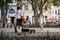 Street musician playing guitar in Odessa park street in summer, surrounded by public and viewers