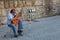 Street musician is playing on his flamenco guitar.