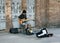 Street musician plays electric guitar, sings and collects alms