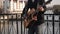 A street musician plays the guitar